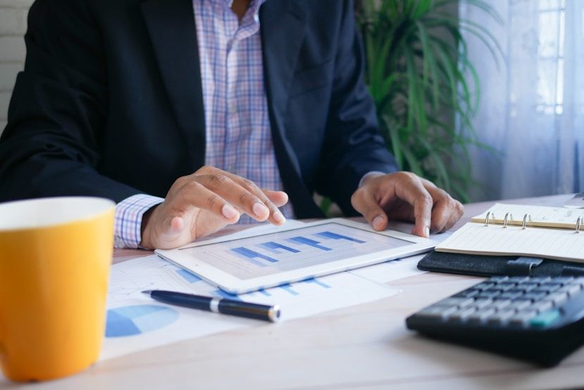Accountant reviewing financial charts next to a calculator