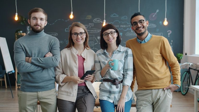 Four startup founders standing together in a modern office