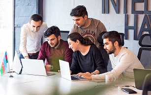 Professionals working on laptops in a shared office