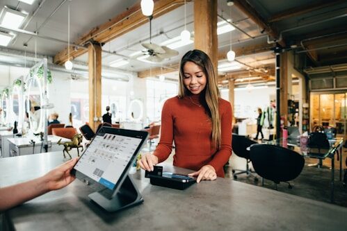 Retail store owner using a point-of-sale tablet