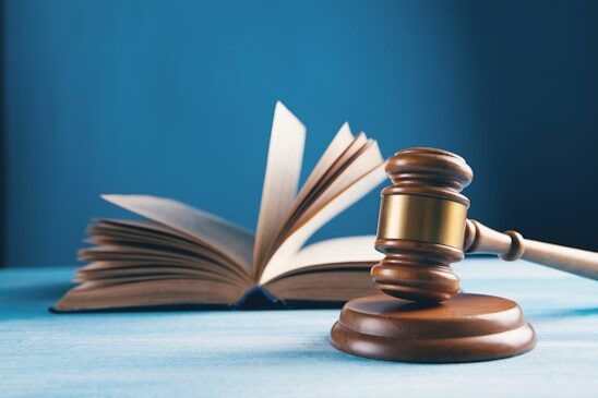 Judge's gavel beside an open law book