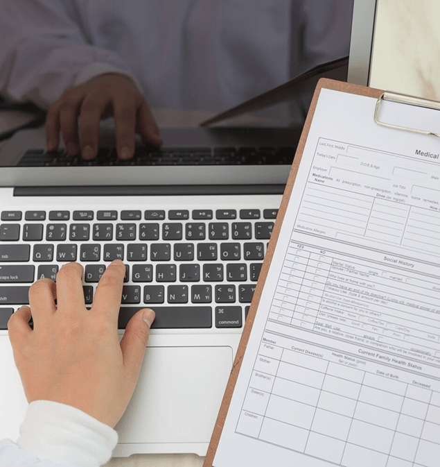 Two finance professionals reviewing printed charts at a desk