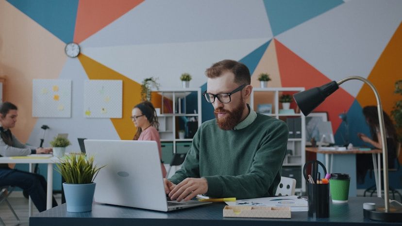 Small business owner working on a laptop at his desk